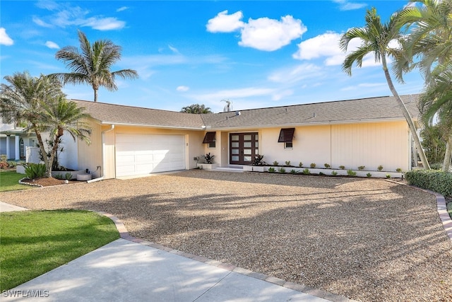 ranch-style home featuring french doors and a garage