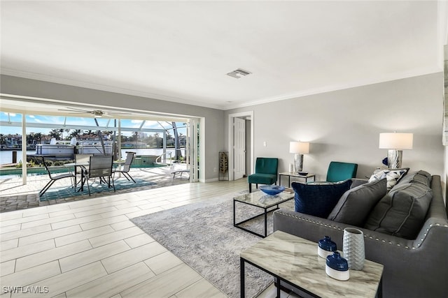 living room featuring a water view and ornamental molding