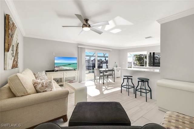 living room with ceiling fan, crown molding, and light tile patterned flooring