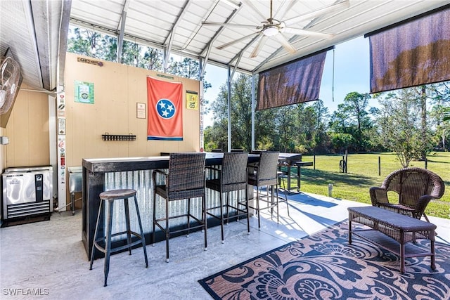 view of patio / terrace featuring ceiling fan and exterior bar