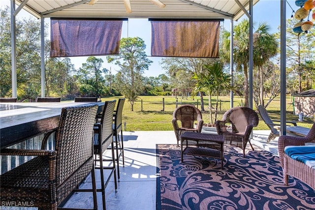 view of patio / terrace with an outdoor bar and ceiling fan