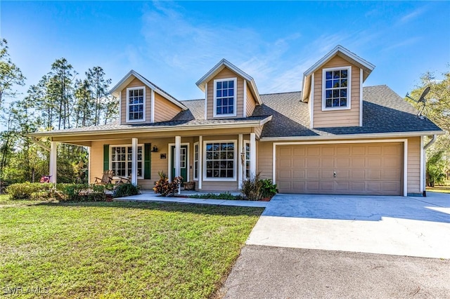 view of front facade featuring a garage, a front lawn, and covered porch