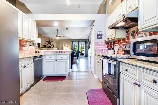 kitchen with white cabinetry, light stone counters, kitchen peninsula, ceiling fan, and stainless steel appliances