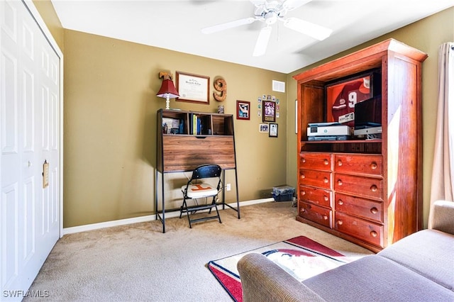 bedroom with ceiling fan, light carpet, and a closet