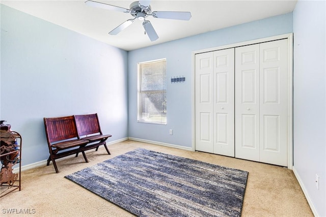 sitting room featuring ceiling fan and light carpet