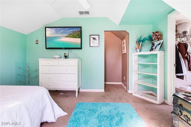 bedroom with a closet, ceiling fan, vaulted ceiling, and light carpet