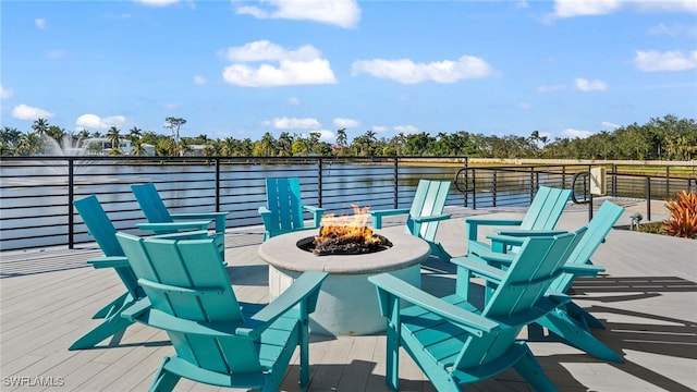 deck featuring a fire pit and a water view