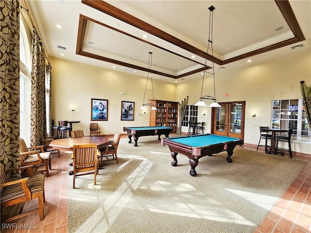 playroom with french doors, a raised ceiling, billiards, a high ceiling, and plenty of natural light