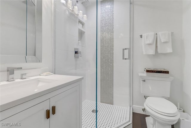 full bath featuring vanity, toilet, and a stall shower