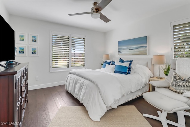 bedroom featuring baseboards, ceiling fan, and dark wood-style flooring