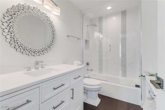 full bathroom with vanity, toilet, wood finished floors, and bath / shower combo with glass door