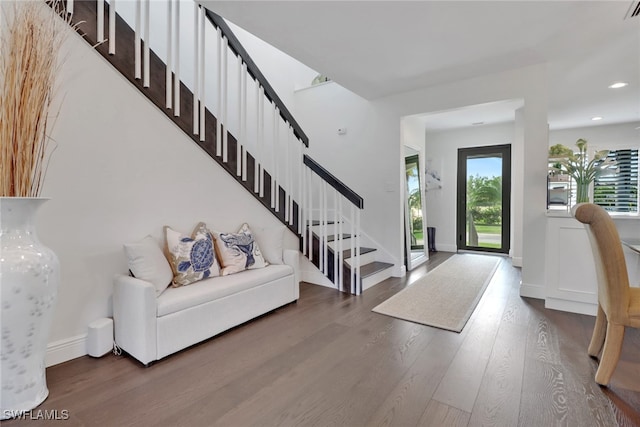 entrance foyer with stairs, baseboards, and wood finished floors