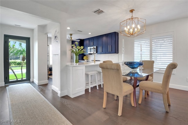 dining space featuring visible vents, dark wood finished floors, recessed lighting, an inviting chandelier, and baseboards