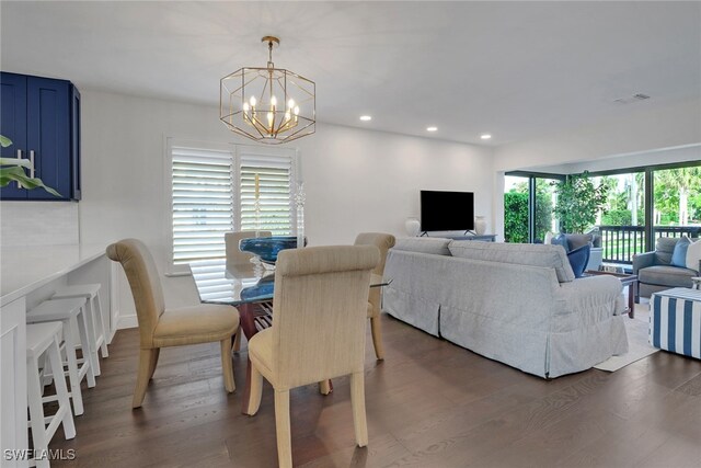 dining room with recessed lighting, visible vents, an inviting chandelier, and wood finished floors