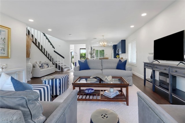 living area with stairway, recessed lighting, a healthy amount of sunlight, and a chandelier