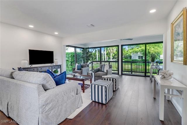 living area with recessed lighting, visible vents, plenty of natural light, and dark wood-style flooring