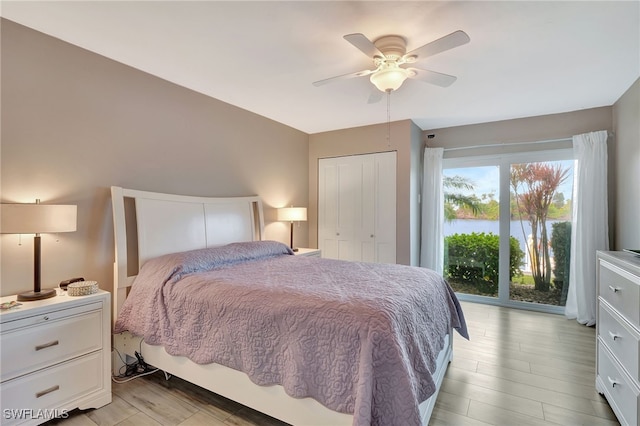 bedroom featuring ceiling fan, light hardwood / wood-style floors, access to outside, and a closet