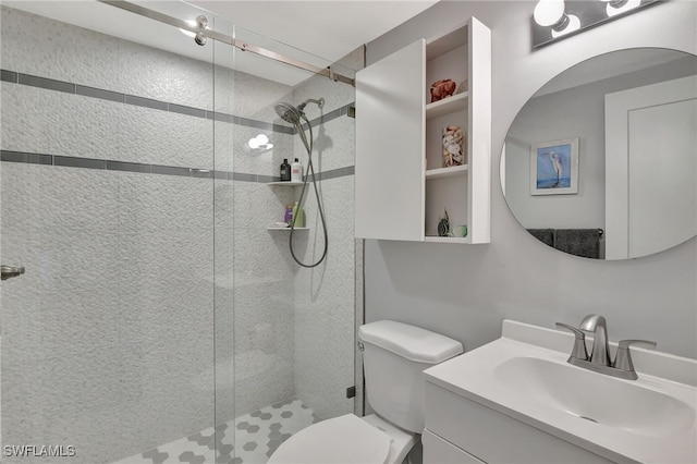 bathroom featuring vanity, toilet, and a shower with shower door