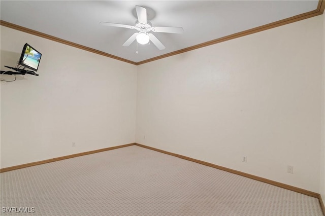 unfurnished room featuring ceiling fan, ornamental molding, carpet, and baseboards