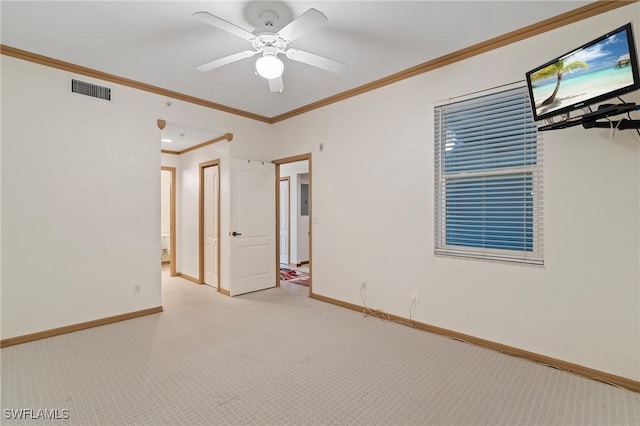 empty room featuring baseboards, ceiling fan, visible vents, and light colored carpet