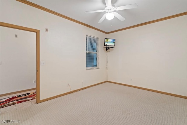 unfurnished room featuring carpet, crown molding, and baseboards