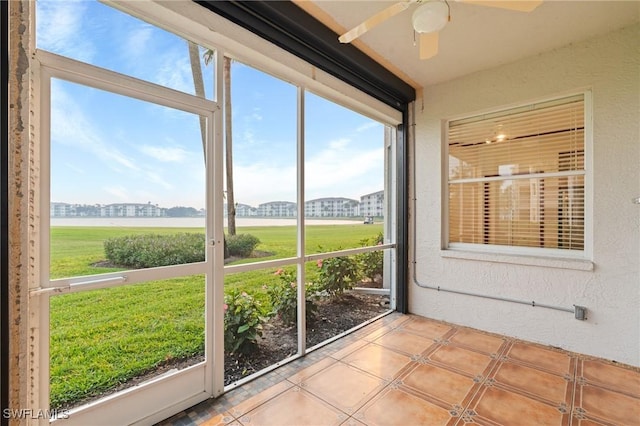 unfurnished sunroom featuring ceiling fan