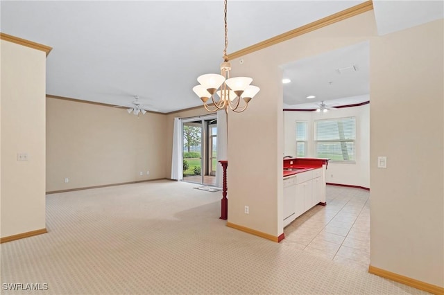 spare room with ornamental molding, light carpet, and baseboards