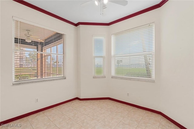 spare room featuring light tile patterned floors, ornamental molding, a ceiling fan, and baseboards