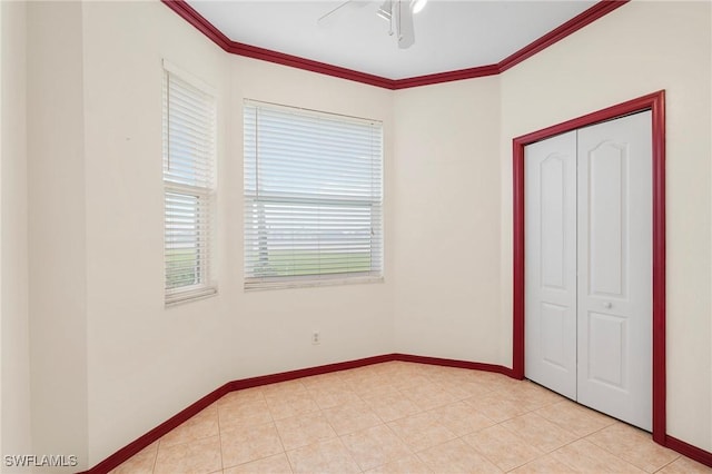 unfurnished bedroom featuring baseboards, multiple windows, and ornamental molding