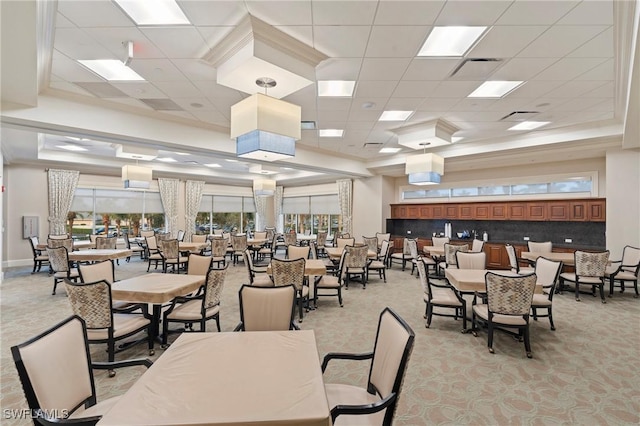 dining space featuring a drop ceiling