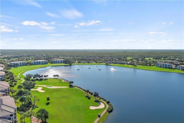 birds eye view of property with view of golf course and a water view