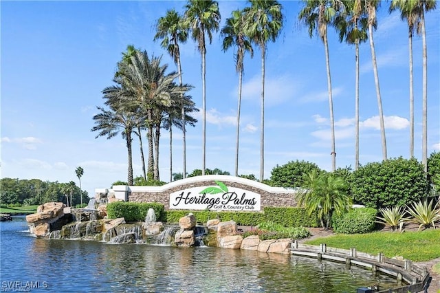 community sign featuring a water view