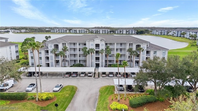 view of building exterior with a water view and central AC unit