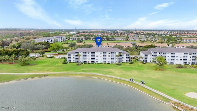 drone / aerial view with view of golf course and a water view