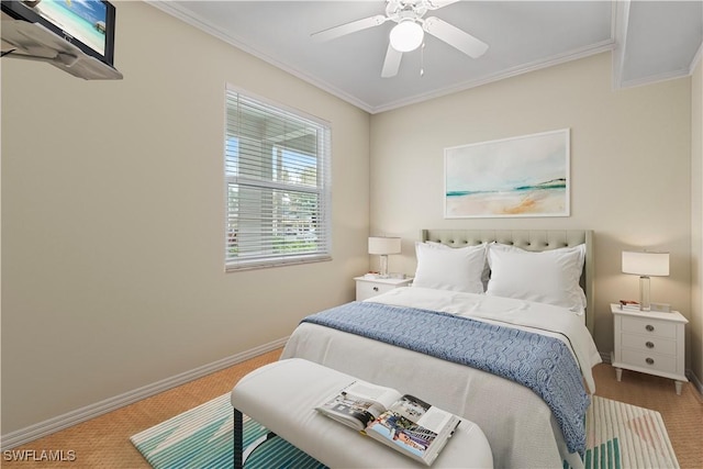 carpeted bedroom with ceiling fan, baseboards, and crown molding