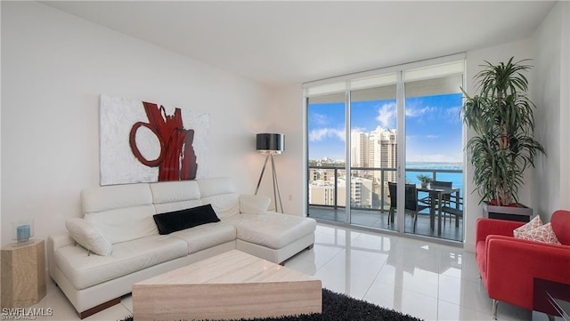 tiled living room with a water view and a wall of windows