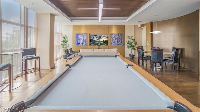 game room with a raised ceiling, wooden ceiling, light wood-type flooring, and billiards