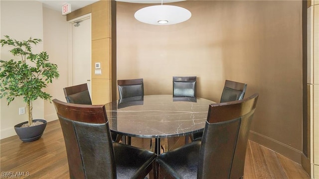 dining space featuring wood-type flooring