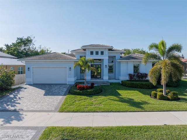 view of front of property featuring a garage and a front yard