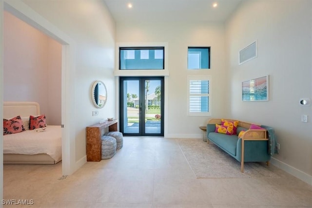 entrance foyer with a towering ceiling and french doors