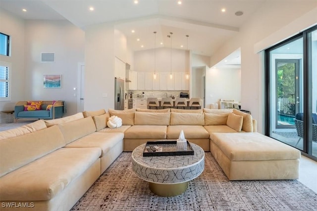 living room featuring high vaulted ceiling