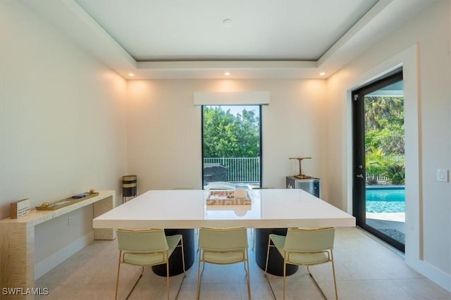 dining area featuring a raised ceiling