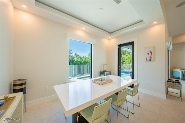 dining room featuring a raised ceiling