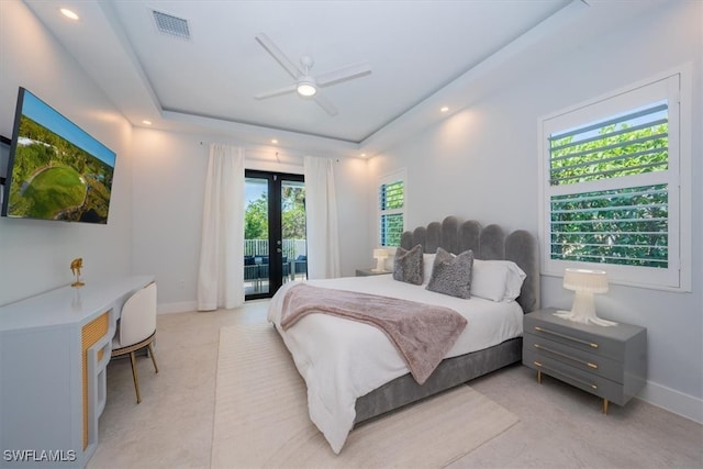 bedroom with a raised ceiling, access to exterior, ceiling fan, and light tile patterned flooring