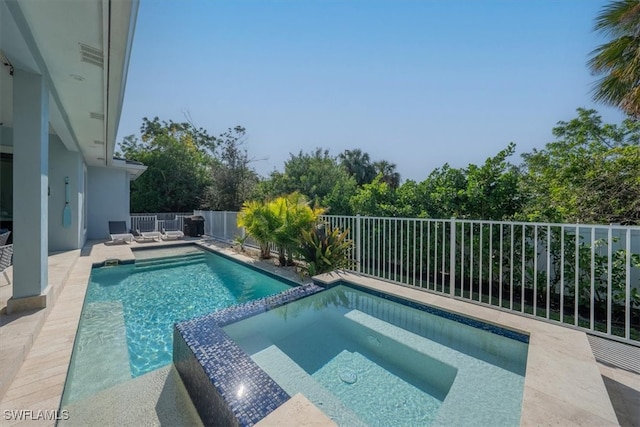 view of swimming pool featuring an in ground hot tub and a patio area