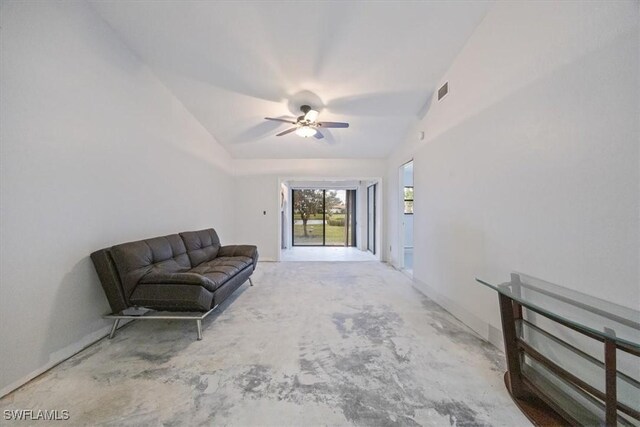 unfurnished room with concrete flooring, ceiling fan, and vaulted ceiling