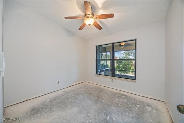 empty room with lofted ceiling and ceiling fan