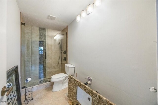 bathroom with walk in shower, tile patterned floors, and toilet