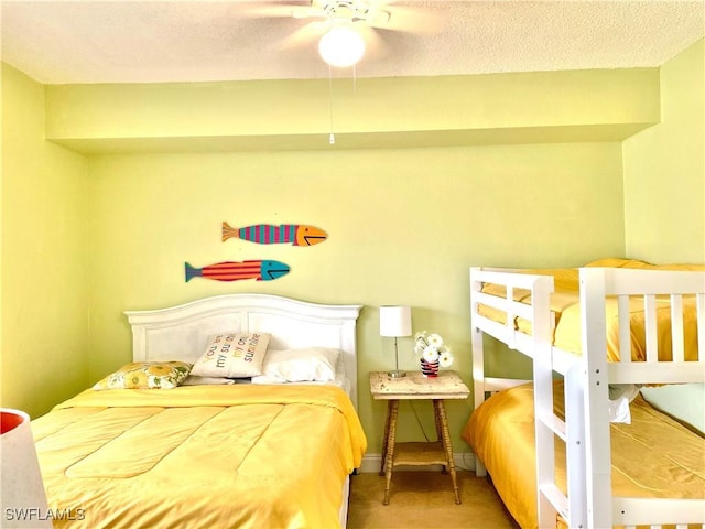 bedroom with ceiling fan and a textured ceiling