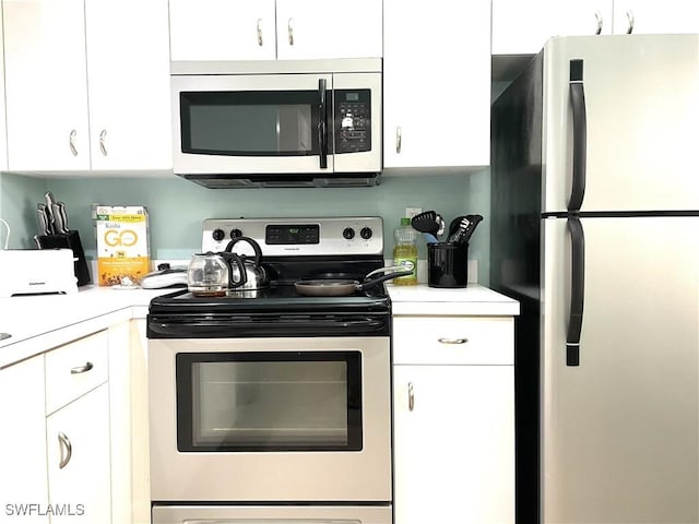 kitchen with white cabinets and appliances with stainless steel finishes